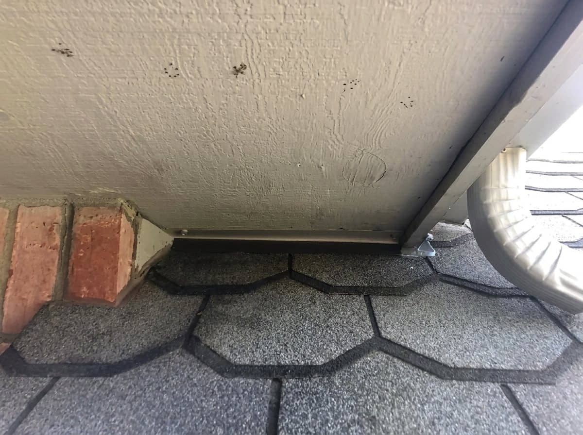 A soffit gap closed with custom cut and bent metal, color matched to the soffit