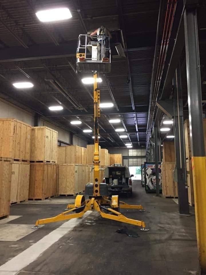 Aerial work platform raised inside a commercial warehouse